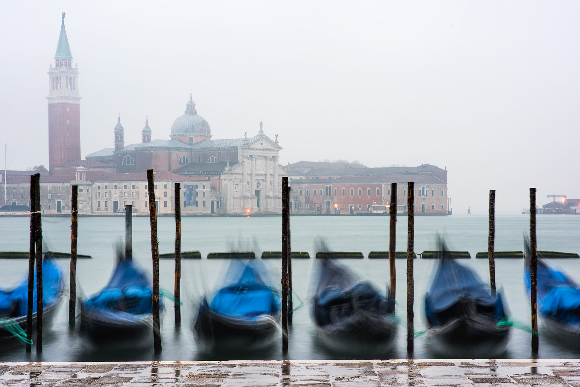 Classic view of Venice and its gondolas in the fog.