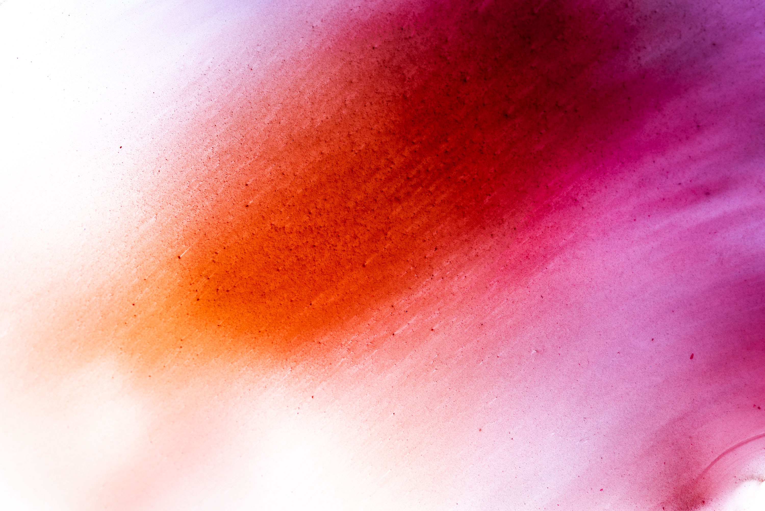 Abstract photography made of orange and pink watercolour. Image by Jennifer Esseiva.