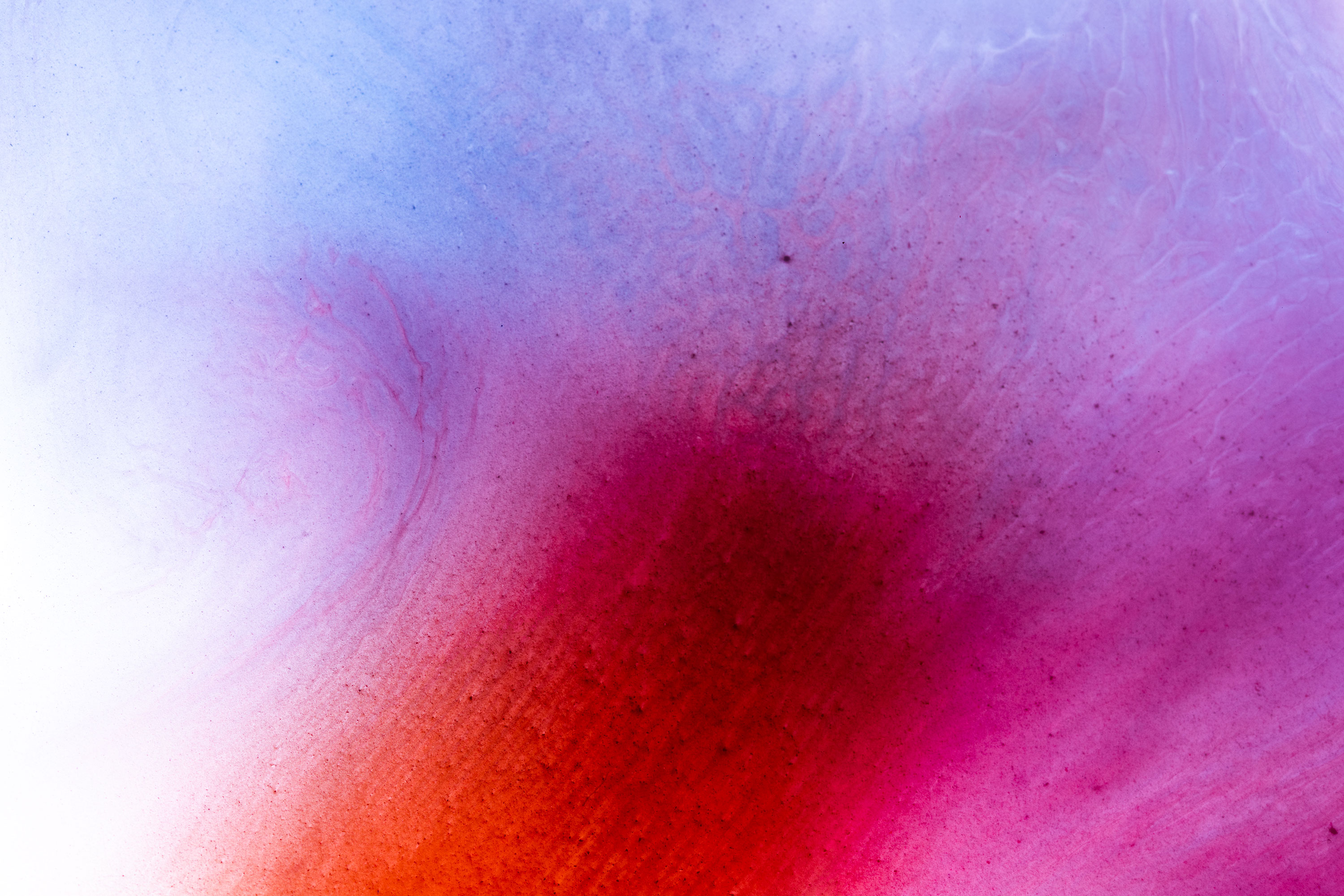 Abstract photography made of orange and blue watercolour. Image by Jennifer Esseiva.