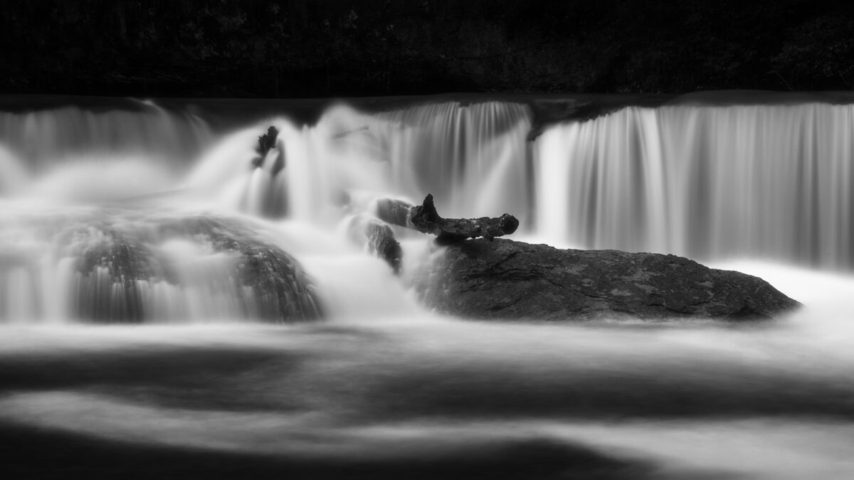 Long exposure black and white photograph of a waterfall in Switzerland.