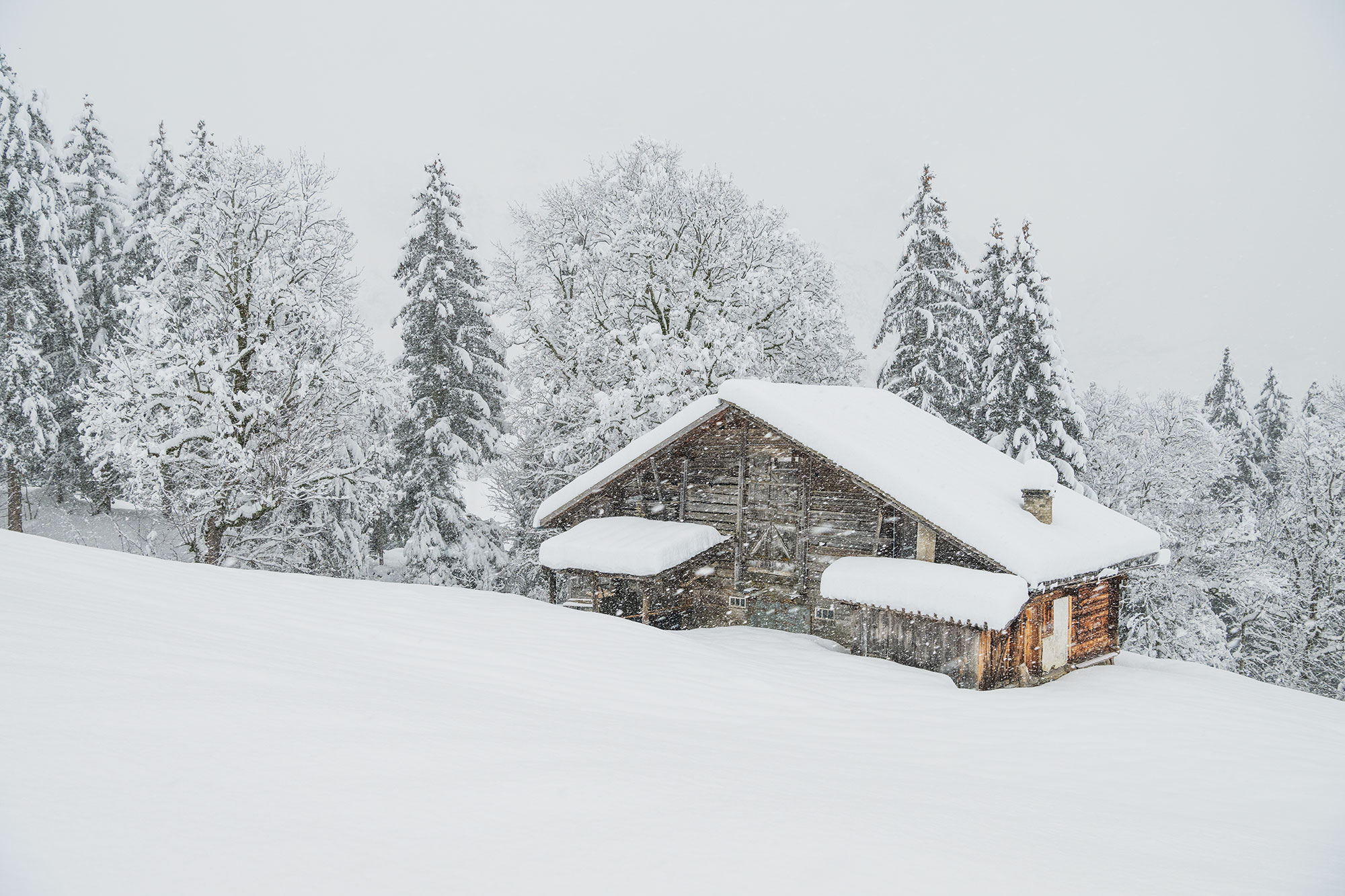 Mountain chalet in Switzerland in a snowstorm.