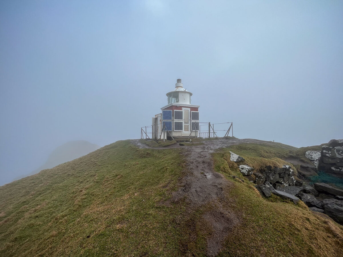 This evocative photograph captures the ethereal beauty of Kallur Lighthouse emerging from the mysterious embrace of fog.