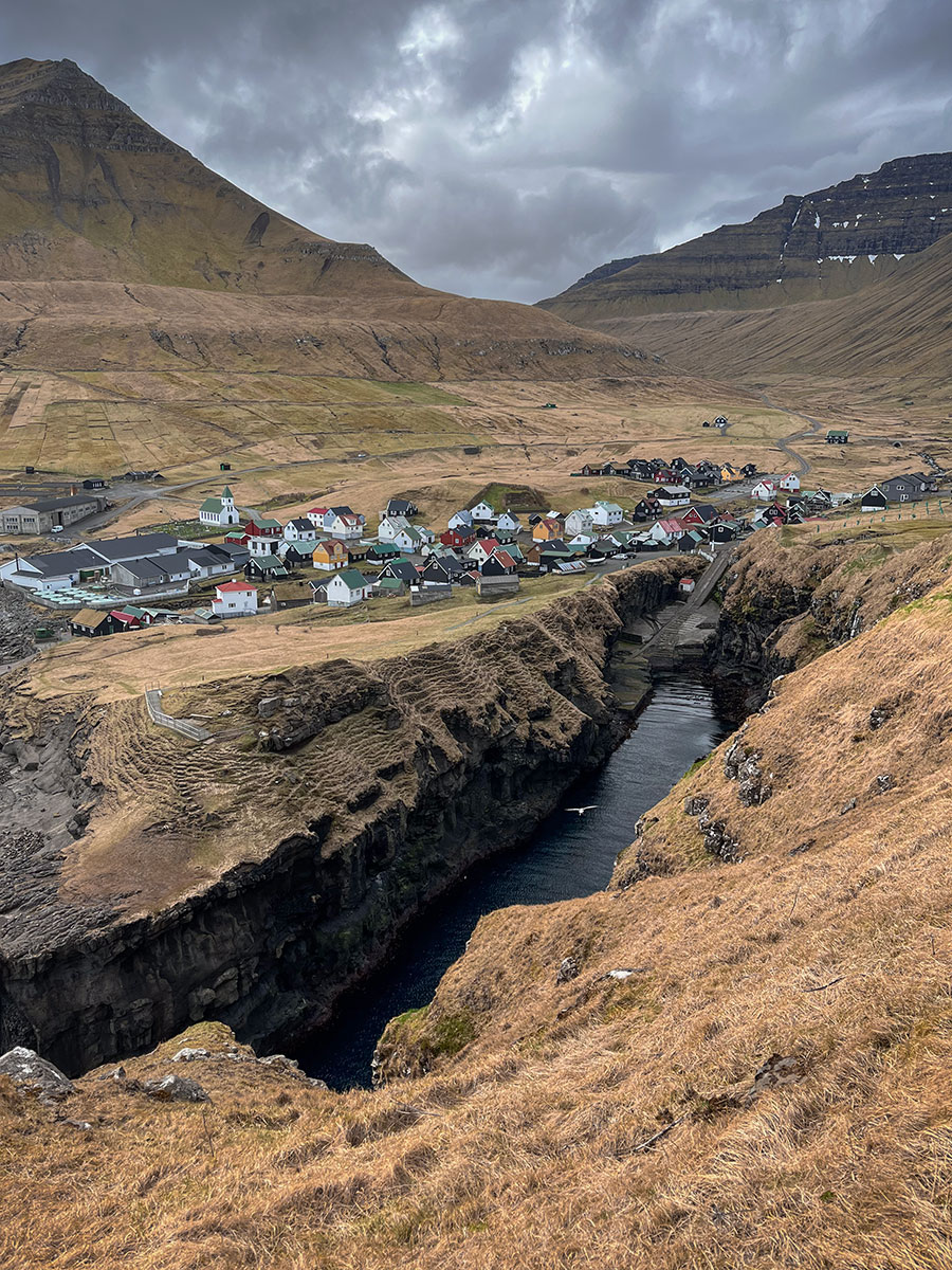 This landscape photograph frames the breathtaking natural harbor of Gjógv in the Faroe Islands.