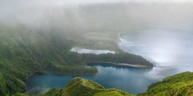 Behold the mesmerizing beauty of Lago do Fogo in São Miguel, captured through the lens of Jennifer Esseiva and her Nikon D810. This epic landscape photography showcases a foggy sunrise over the tranquil waters, enveloping the scene in an ethereal mist. Despite the raining morning, the serene ambiance of the lake remains undisturbed, offering a captivating view of nature's serene allure. Join Esseiva on this visual journey through São Miguel's breathtaking vistas, where every frame tells a story of the island's timeless charm and natural splendor.