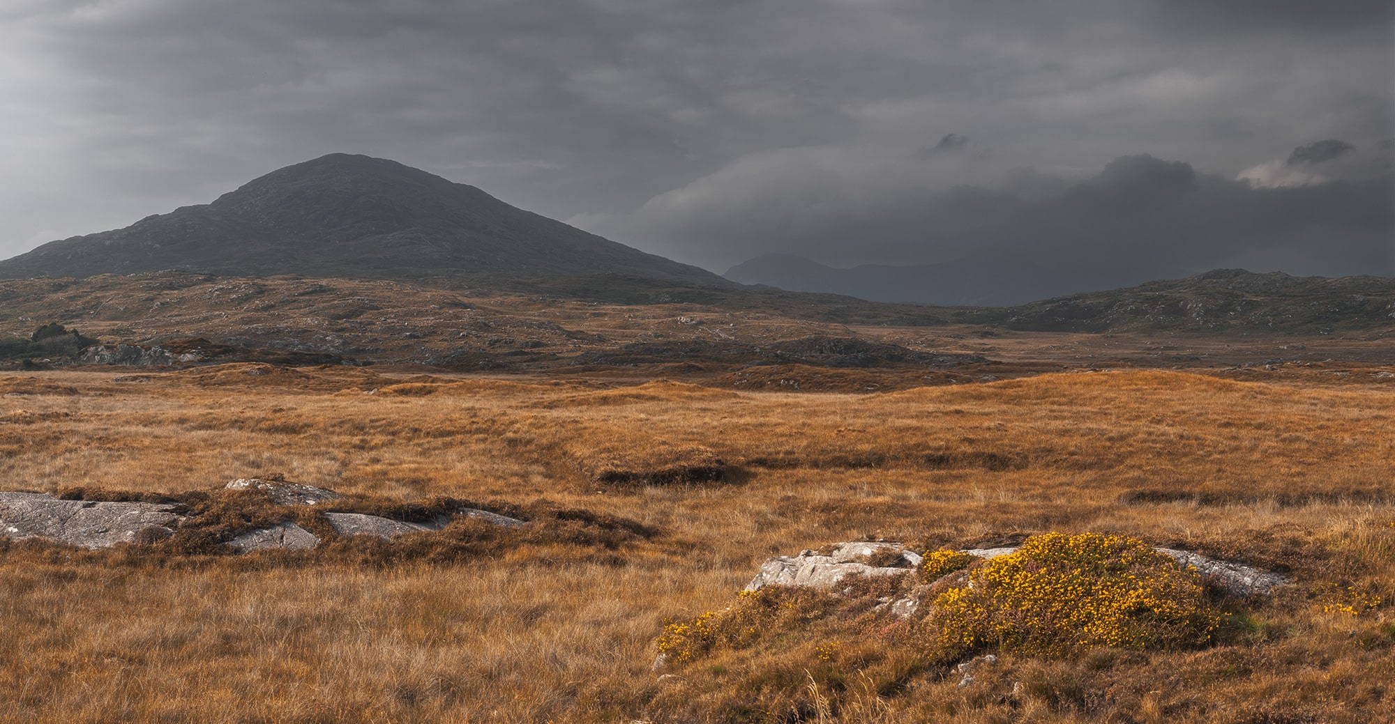 Embark on a visual journey through the untamed beauty of Connemara, near Galway in Ireland, with this epic landscape photography captured by Swiss photographer Jennifer Esseiva and her Nikon D810. Immerse yourself in the rugged wilderness and raw natural splendor of Connemara's rough landscape, where wild nature reigns supreme. This wide-angle photograph invites you to explore the vast expanses of Connemara, where every corner reveals a breathtaking vista waiting to be discovered. Join Jennifer Esseiva on this captivating exploration of Ireland's wild heartland, where the beauty of the land knows no bounds.