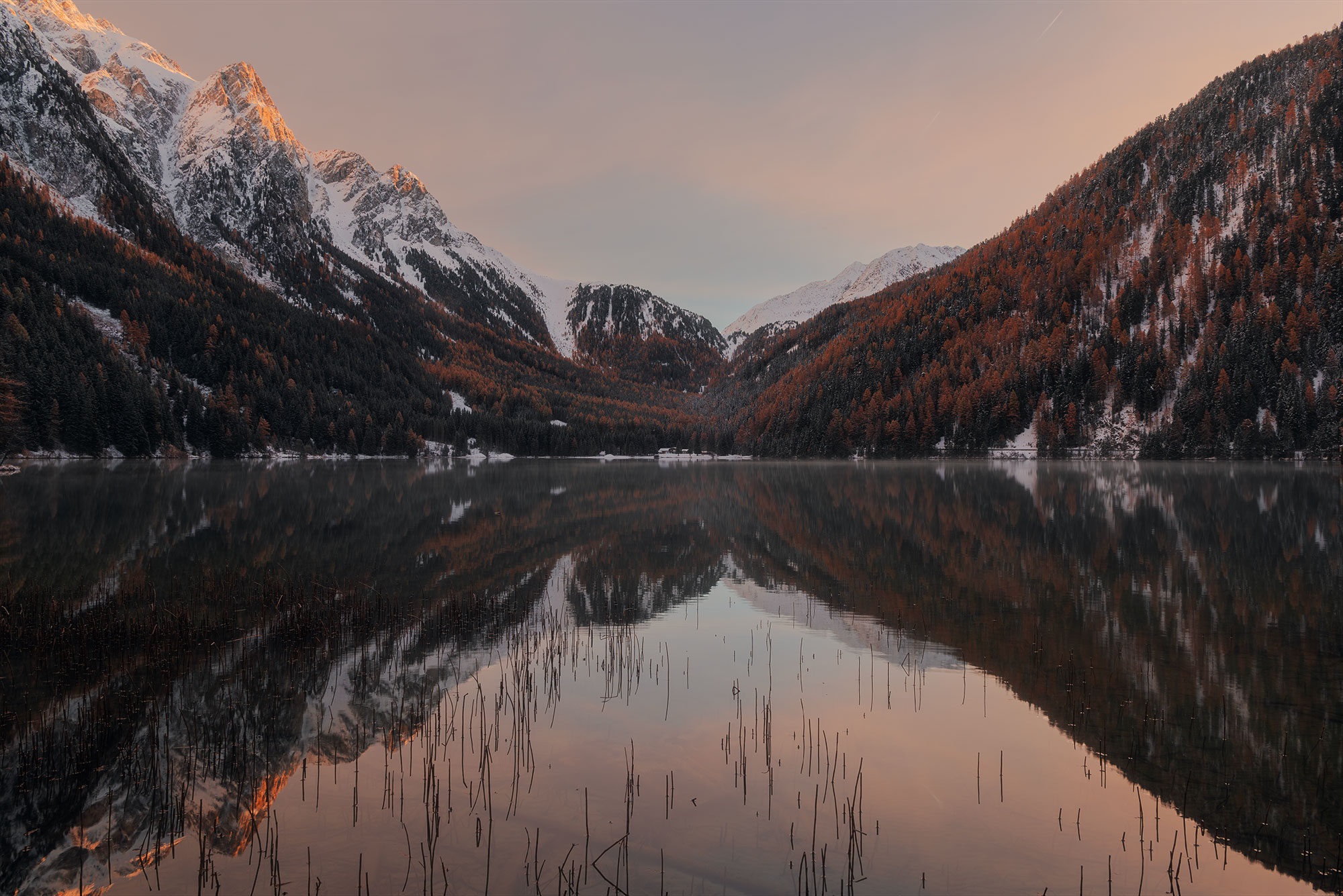 Embark on a visual journey through the stunning landscapes of the Dolomites, Italy, with acclaimed photographer Jennifer Esseiva. Witness the mesmerizing beauty of an orange sunrise over the tranquil Anterselva lake, expertly captured by Jennifer's skilled hands and her trusted Nikon D810 camera. Each image tells a story of nature's breathtaking splendor, inviting viewers to immerse themselves in the ethereal charm of Italy's iconic scenery. Let Jennifer Esseiva's captivating photographs transport you to a world where every sunrise paints the sky with hues of orange and gold, illuminating the majestic peaks of the Dolomites in a breathtaking display of beauty. Experience the magic of landscape photography at its finest, courtesy of Jennifer Esseiva's masterful artistry.