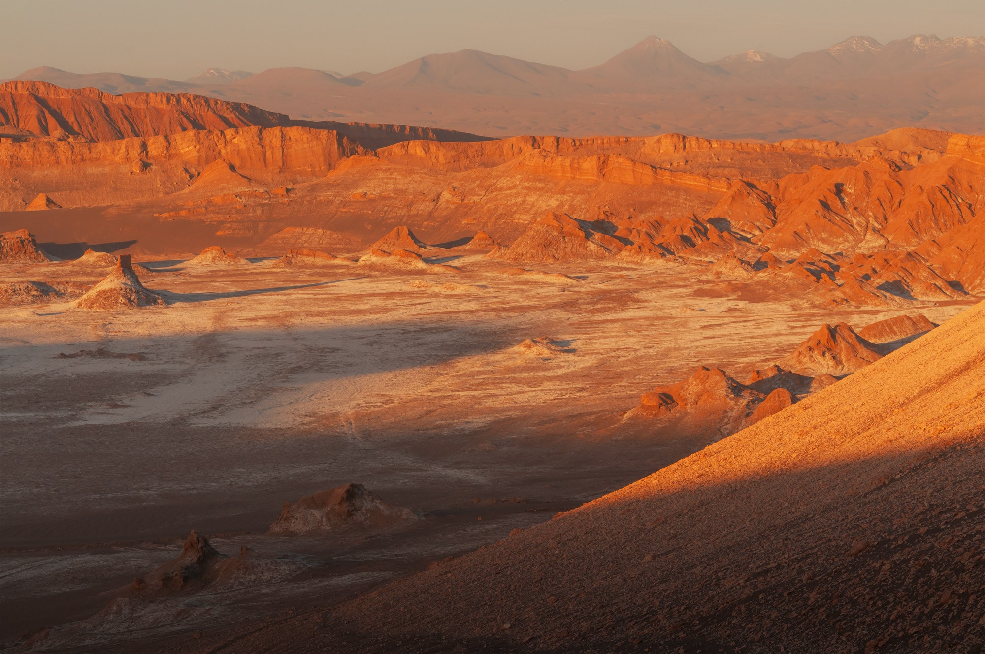 Indulge in the breathtaking beauty of the Atacama Desert's Valley of the Moon with this captivating sunset photograph taken by Swiss photographer Jennifer Esseiva. As the sun dips below the horizon, warm hues cascade over the unique rock formations, creating a stunning visual spectacle in northern Chile. Esseiva's expert lens captures the essence of this magical moment, showcasing the vibrant colors and otherworldly landscapes that define the Valley of the Moon. Immerse yourself in the tranquility and majesty of the Atacama Desert through Esseiva's skillful composition, where nature's artistry is unveiled in every detail. Experience the awe-inspiring sunset that transforms this arid terrain into a captivating masterpiece, expertly documented by the talented Swiss photographer, Jennifer Esseiva.