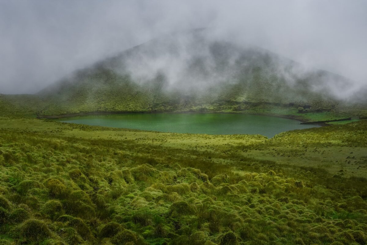 Embark on a mesmerizing journey through the mystical landscapes of Pico Island in the Azores with this captivating image captured by Jennifer Esseiva and her Nikon D810. As the fog rolls in, Lake Peixinho is veiled in an ethereal mist, creating a sense of mystery and enchantment. The mystical Terra Alta adds to the otherworldly atmosphere, inviting viewers to explore its hidden secrets. This scene perfectly encapsulates the essence of a road trip on Pico Island, where every twist and turn reveals a new wonder of nature. Join Esseiva on this visual odyssey, where her expert eye for landscape photography captures the magic and allure of the Azorean landscape in all its glory.