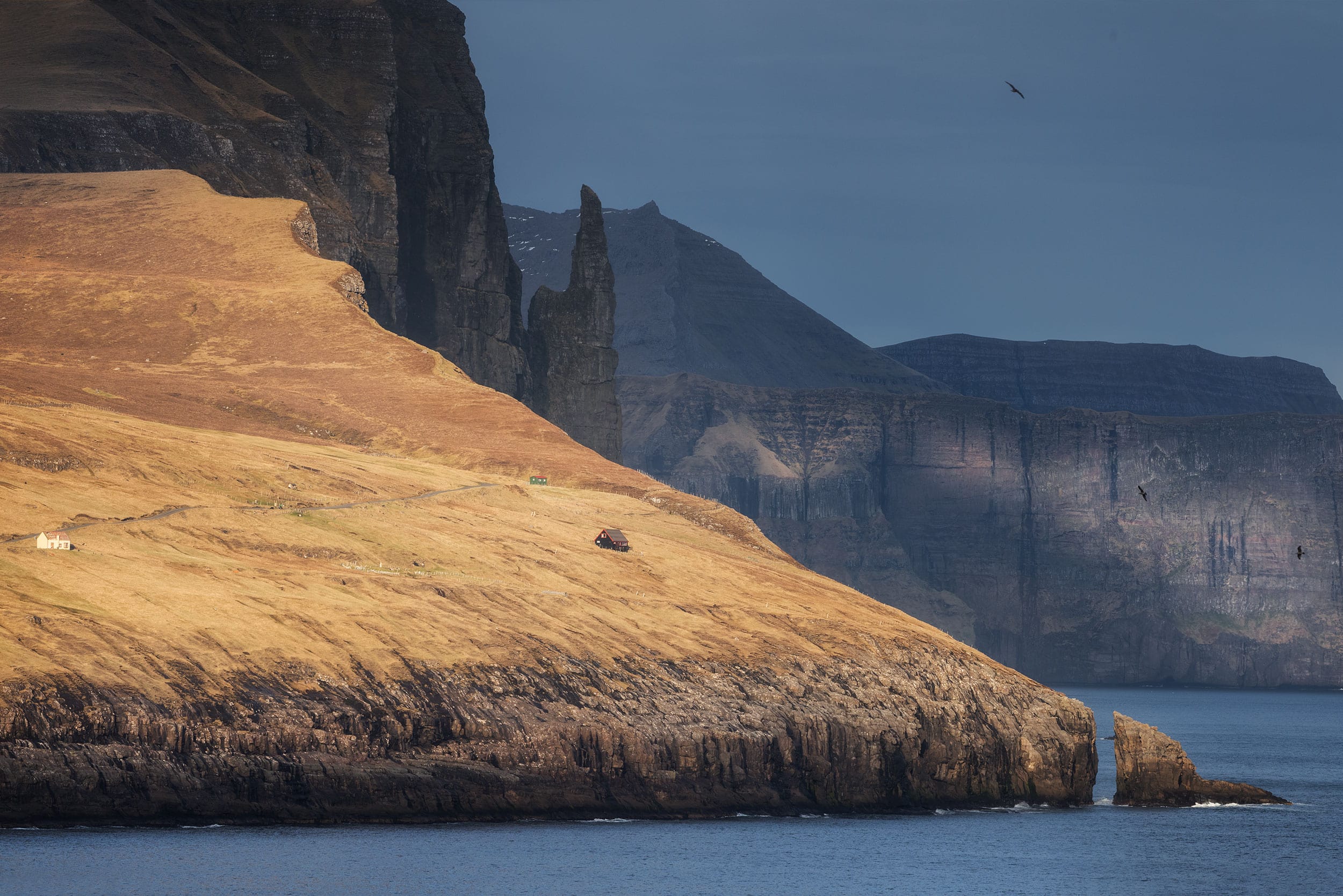 Delve into the breathtaking landscapes of the Faroe Islands with this captivating landscape photograph showcasing the iconic Trøllkonufingur rock formation. As a renowned landmark of the Faroe Islands, Trøllkonufingur mesmerizes with its rugged beauty and mythical allure. Experience the raw majesty of this legendary rock through the lens of our landscape photography collection.