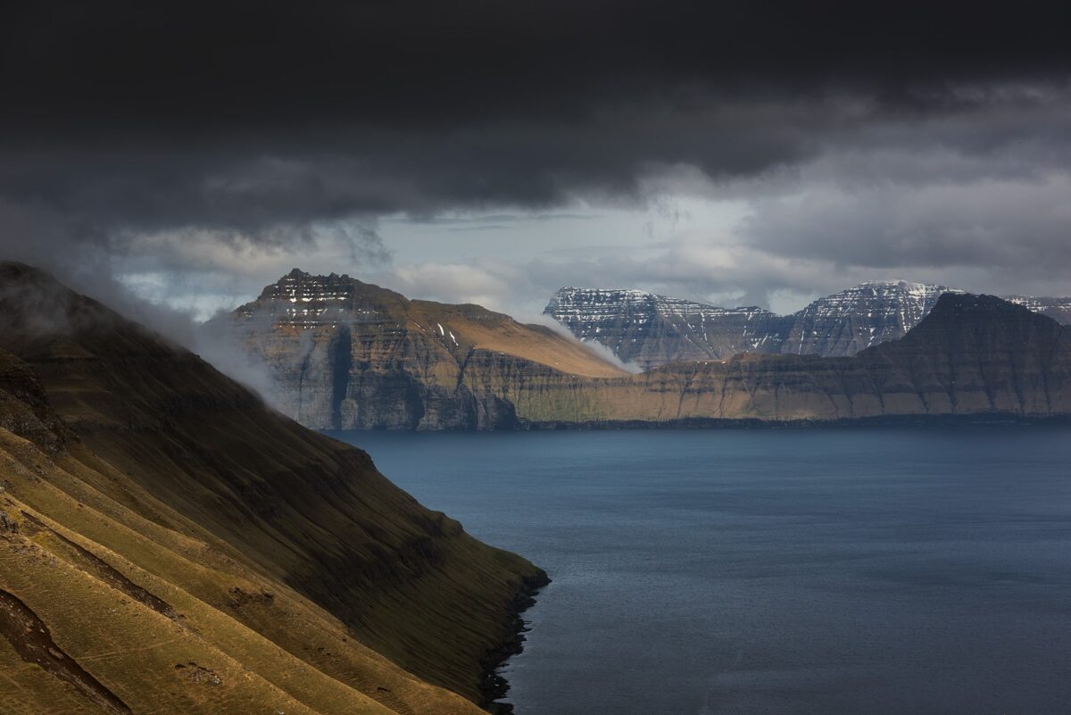 View of Kalsoy Island from Hvíthamar viewpoint, Faroe Islands, with rugged cliffs and ocean landscape.