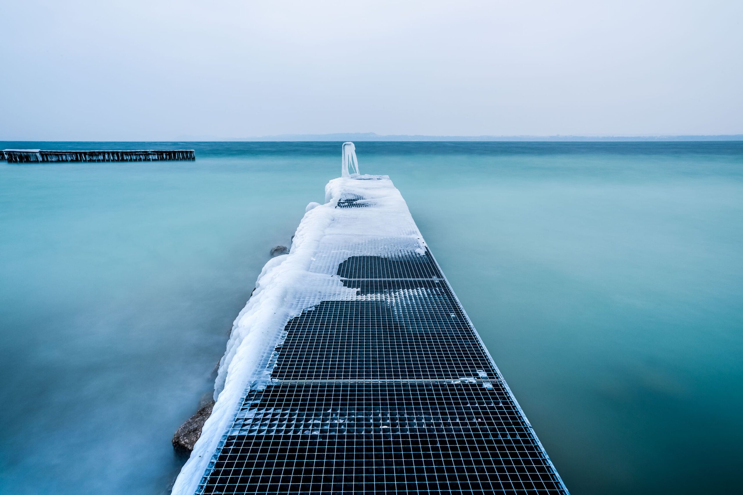 Explore the enchanting sight of an icy pier nestled in the picturesque village of Boudry, located in the scenic canton of Neuchâtel. Captured through the lens of landscape photographer [Your Name], this captivating image showcases the serene beauty of the winter landscape. Immerse yourself in the tranquility of this snowy scene and discover the wonders of Switzerland's natural charm through [Your Name]'s portfolio of stunning landscape photography.
