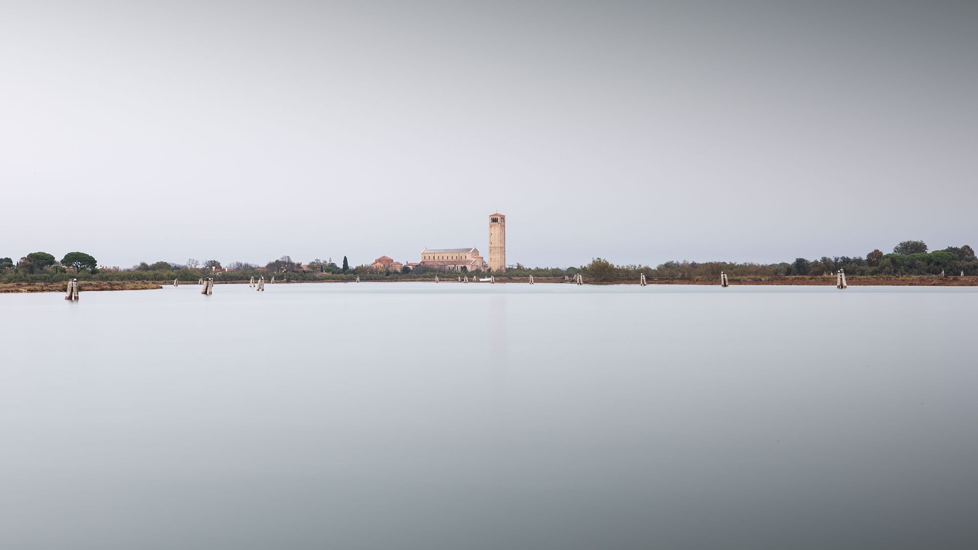 Minimalist landscape photography capturing a long exposure seascape of Torcello, an island near Venice, Italy.