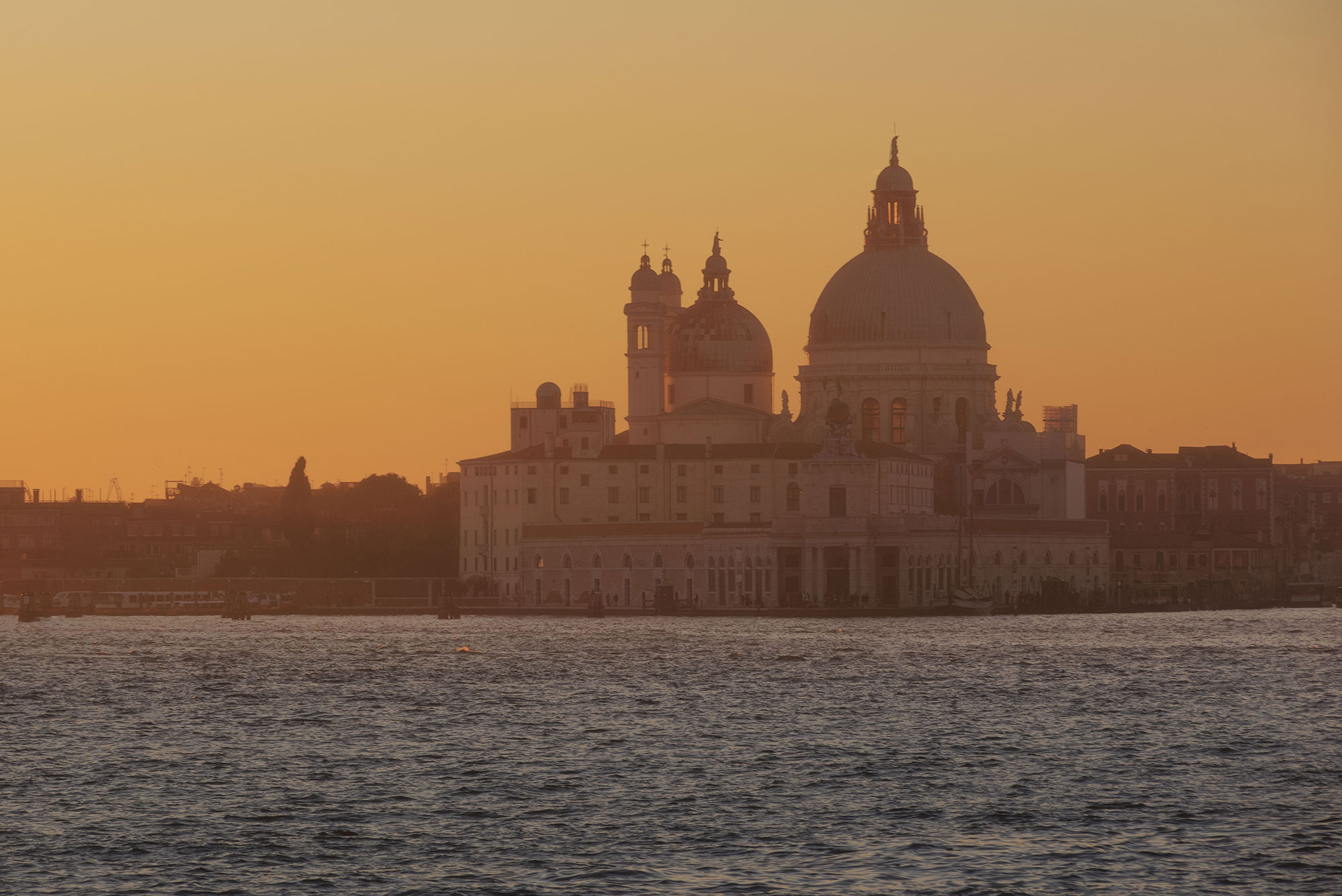 Landscape photography capturing a sunset in Venice, Italy, during the golden hour.