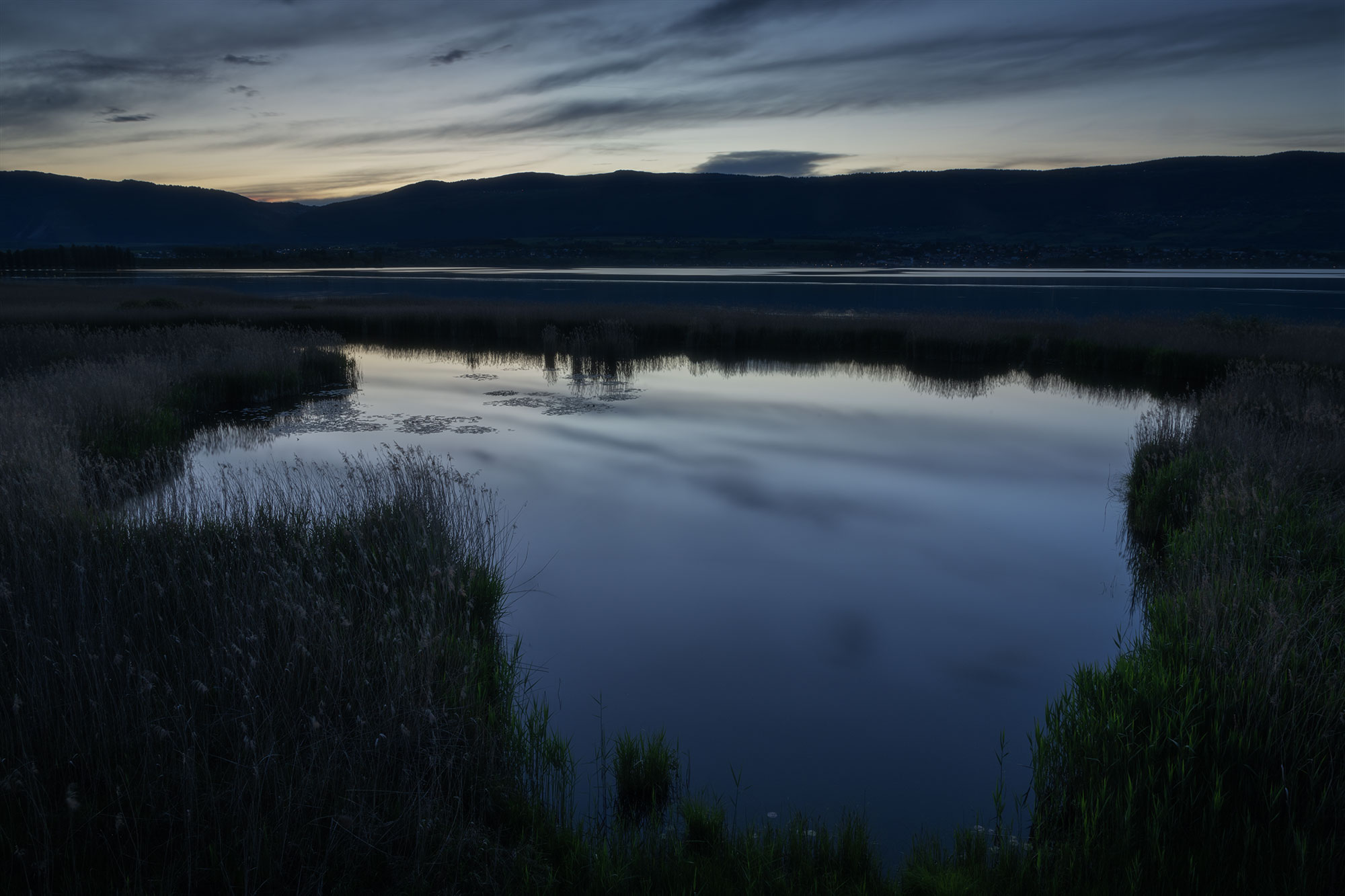 Landscape photography capturing twilight at the Grande Cariçaie nature reserve in Lake Neuchâtel, Switzerland. Photo taken with the Nikon Z8.