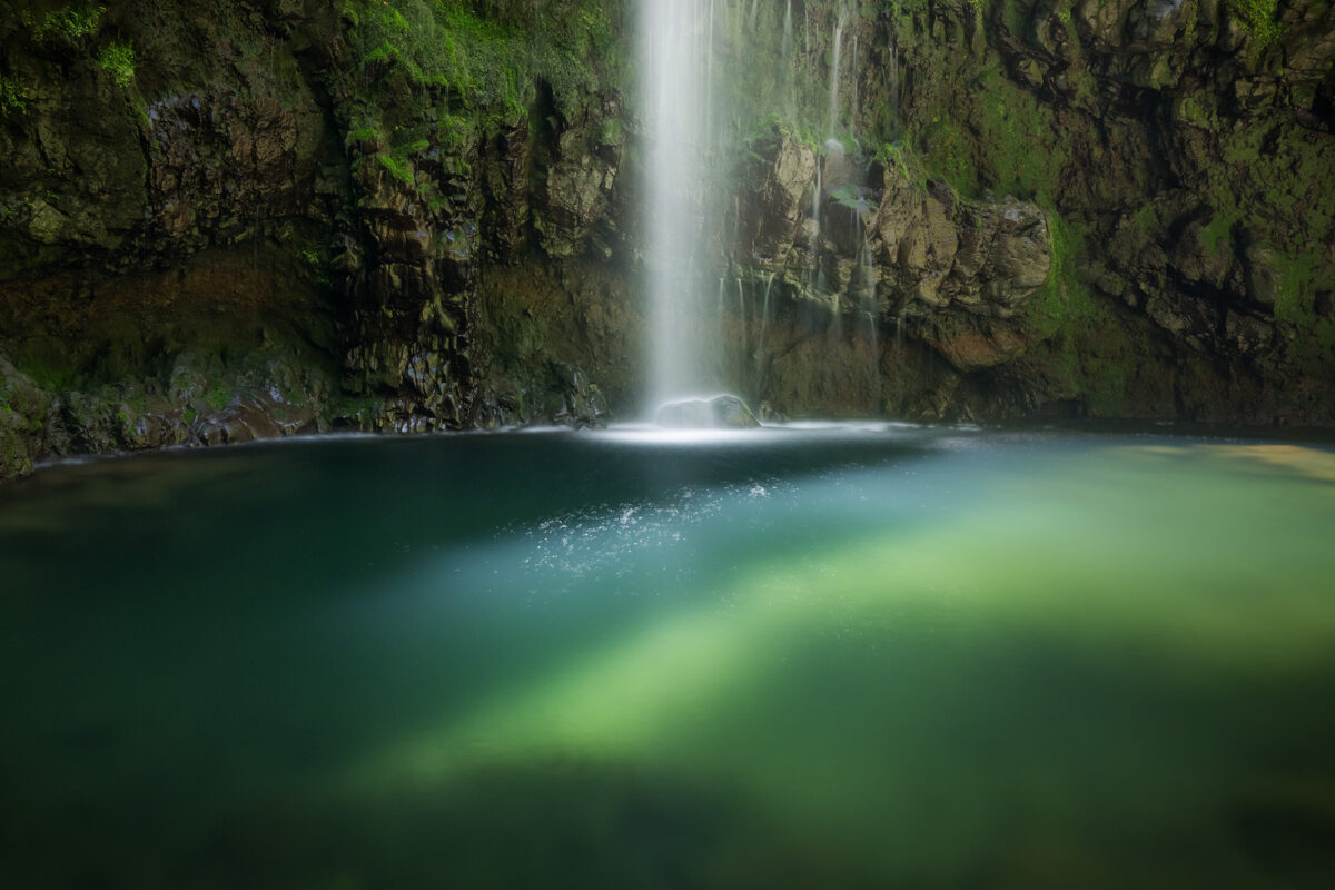 Long exposure of Caldeirão Verde waterfall in Madeira, Portugal, with silky water and mossy green cliffs.