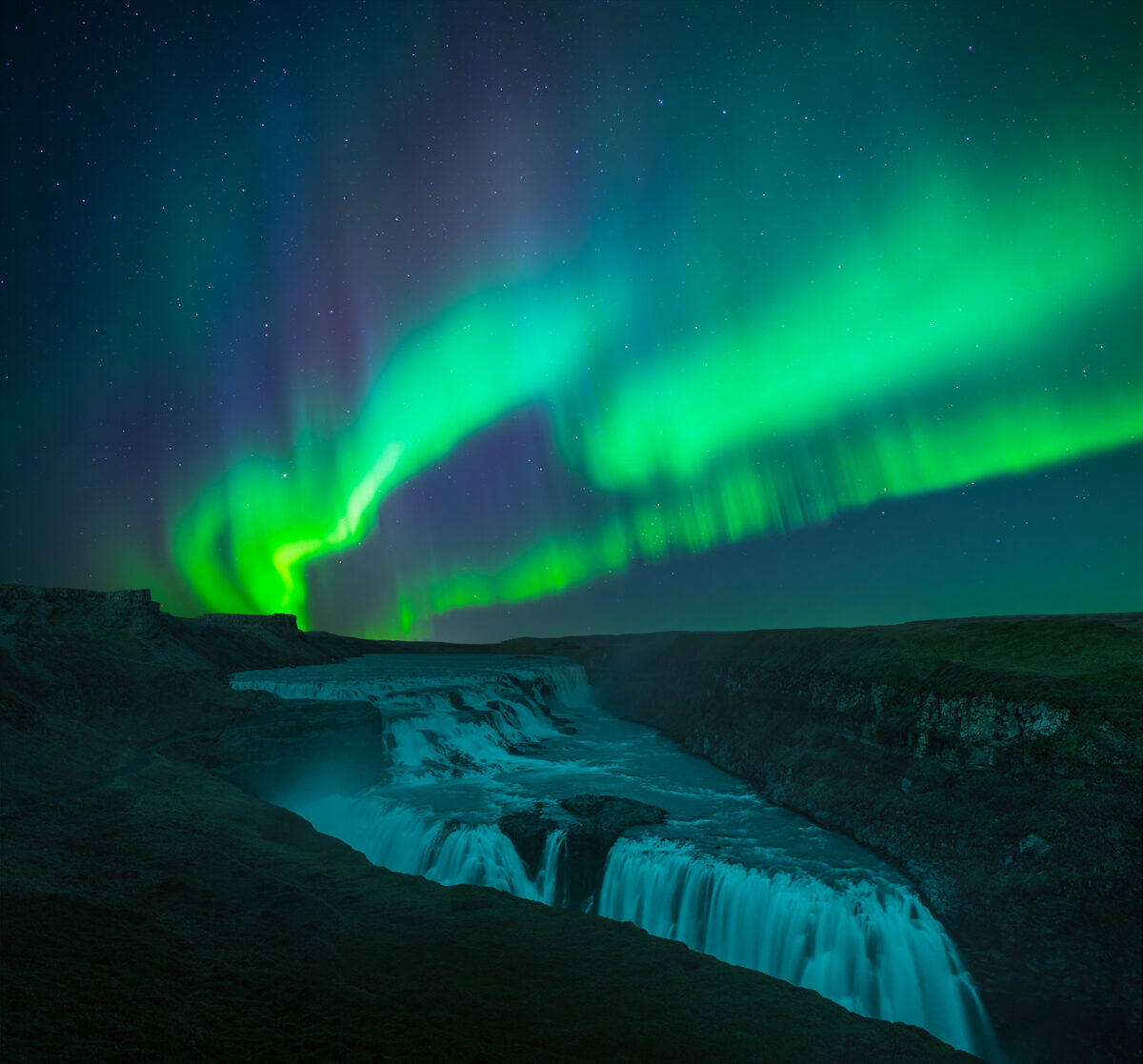 Experience the enchanting beauty of northern lights landscape photography with Jennifer Esseiva. This breathtaking shot, taken at Gullfoss waterfall along Iceland’s Golden Circle, captures the aurora borealis illuminating the skies. Photographed with her Nikon Z8, it highlights Iceland's iconic black sand dunes under the magical glow of the northern lights.