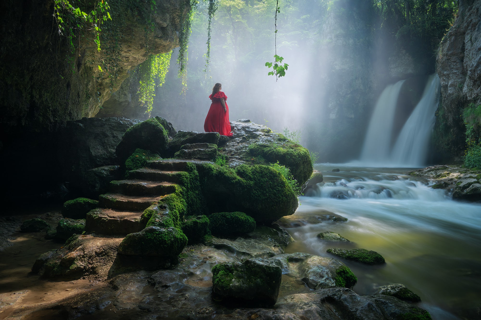 Self-portrait in red dress at Tine de Conflens waterfall – landscape photography in Canton Vaud, Switzerland.
