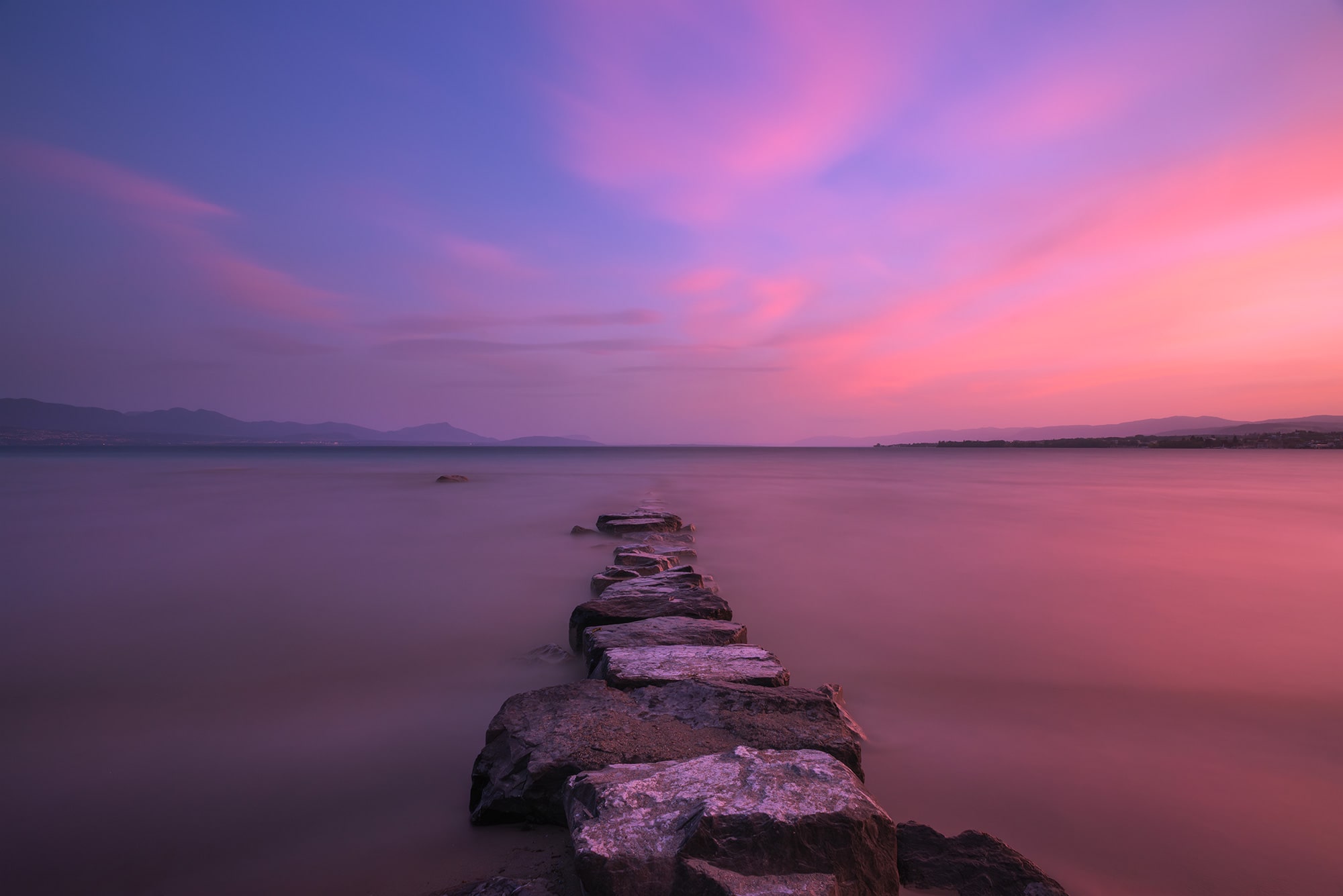 Landscape photography of Lake Geneva taken from Préverenges Beach at sunset in summer.