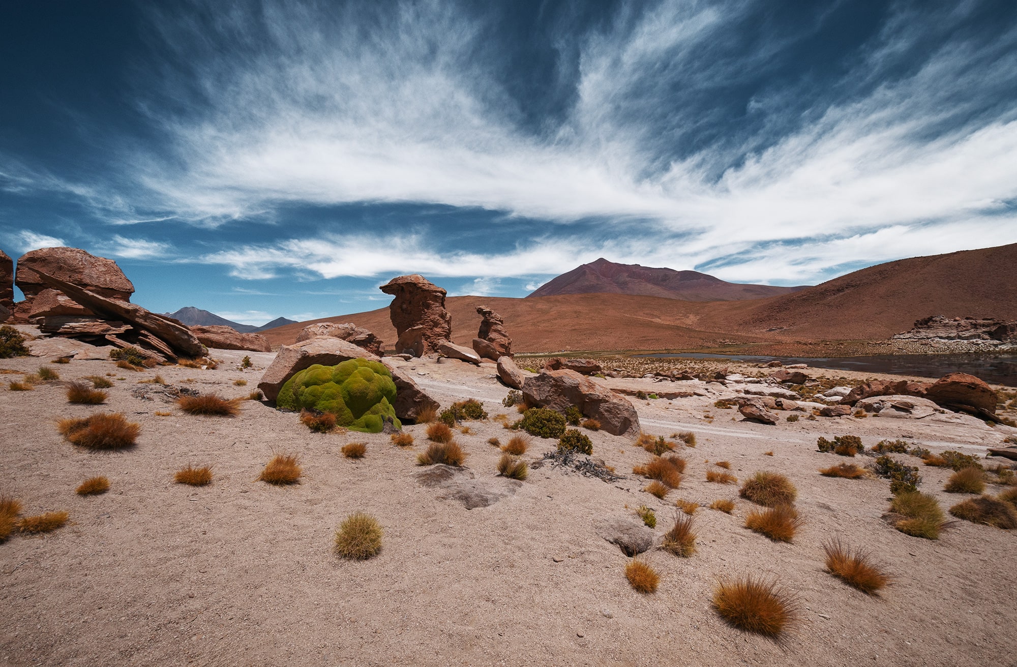 Landscape photography of the mineral Bolivian Altiplano between San Pedro de Atacama in Chile and the Salar de Uyuni, showcasing arid high-altitude desert scenery.
