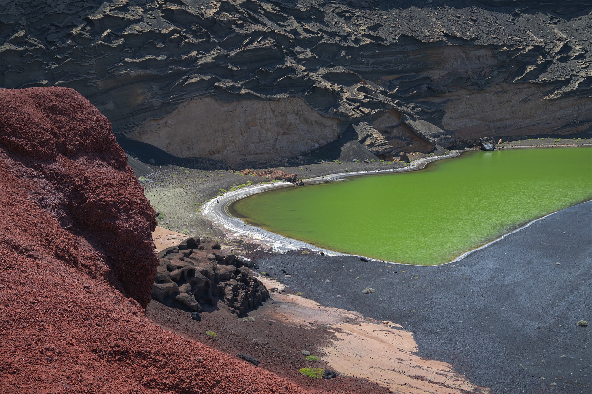 Landscape photography in Lanzarote capturing Los Clicos green lagoon in the Canary Islands with a Nikon Z8, showcasing vibrant volcanic cliffs, emerald waters, and dramatic coastal scenery.