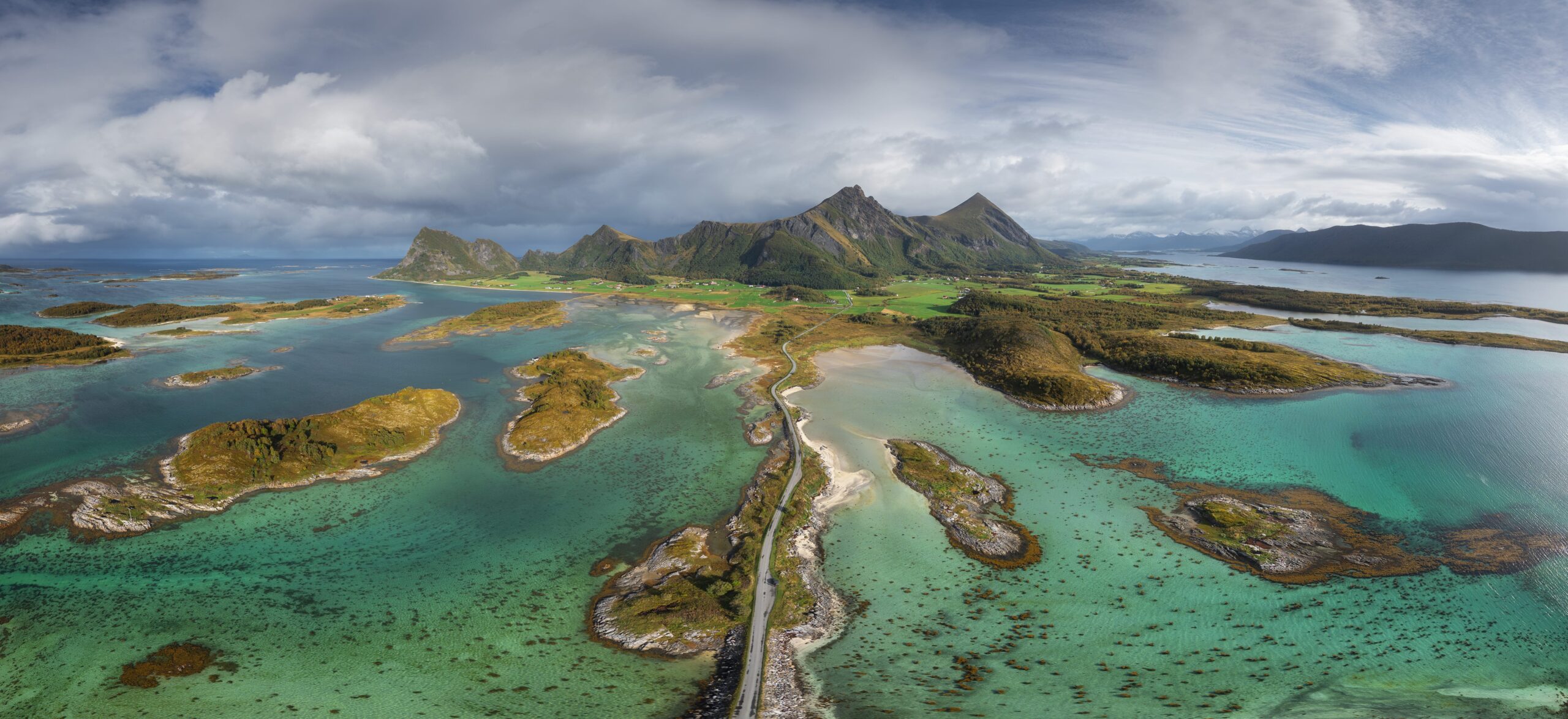 Panoramic drone landscape photography of Røssøya and Engeløya in the Steigen region of northern Norway, captured from above with rugged coastlines and Arctic islands surrounded by the sea.