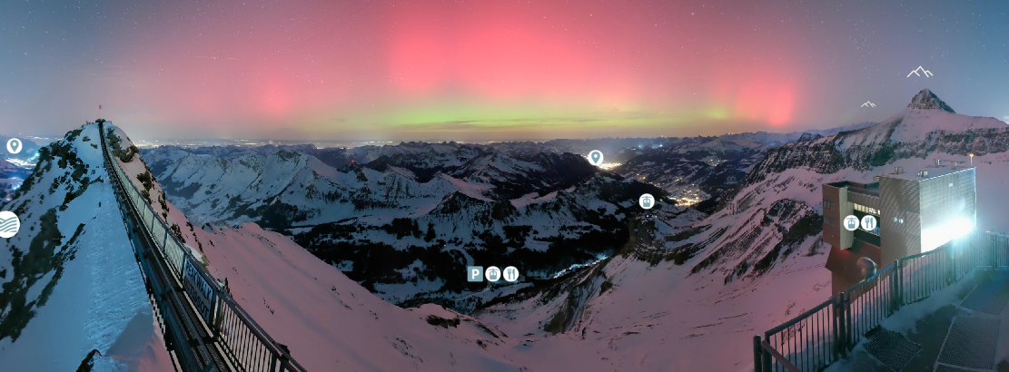 Webcam view of the northern lights above Glacier 3000 in Switzerland on January 19, 2026, with aurora borealis glowing over the alpine landscape during an exceptional solar event.