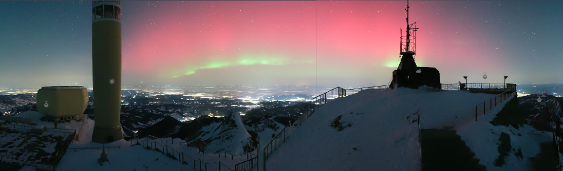 Webcam image of the northern lights over Säntis, Switzerland, captured on January 19, 2026, showing aurora borealis visible above the Alps during a rare geomagnetic storm.