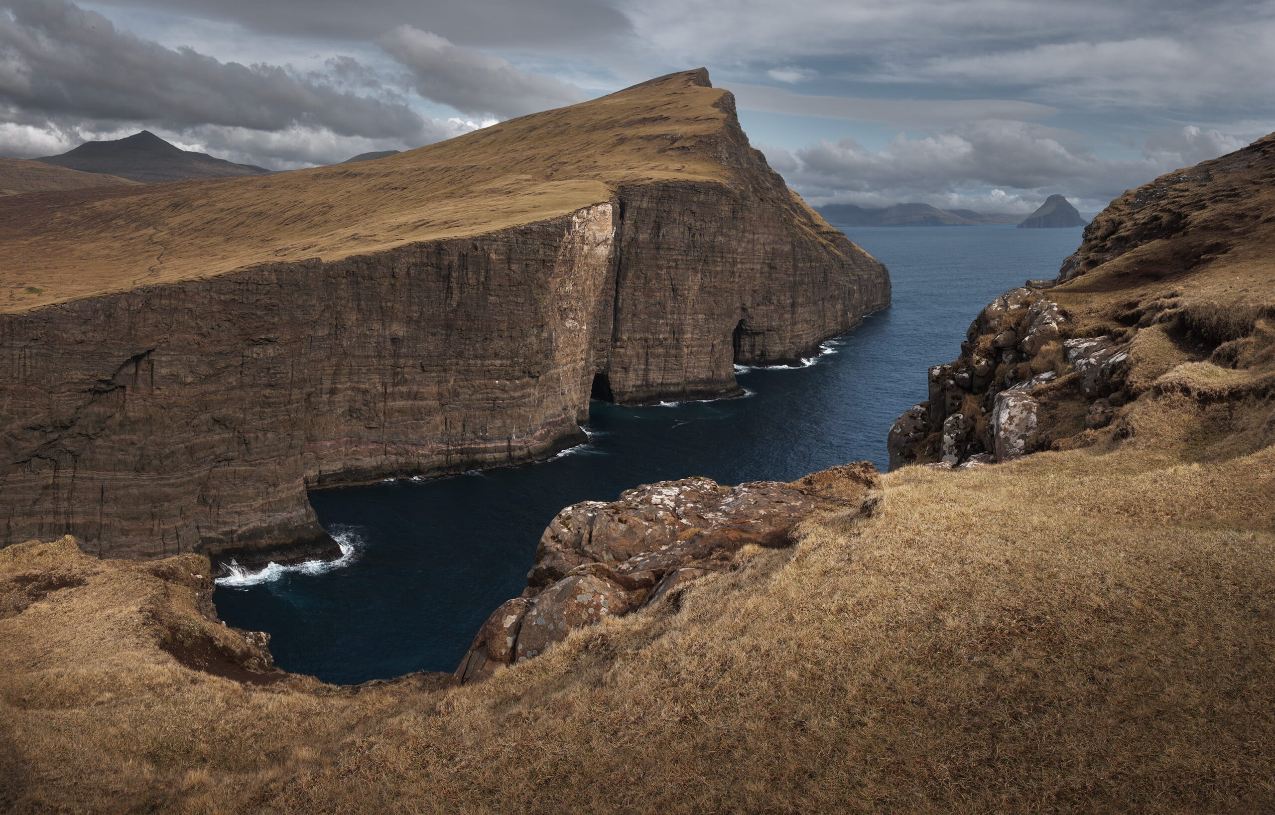 Dramatic view of Trælanípa cliffs above the Atlantic Ocean with rugged coastline, Vágar Island, Faroe Islands
