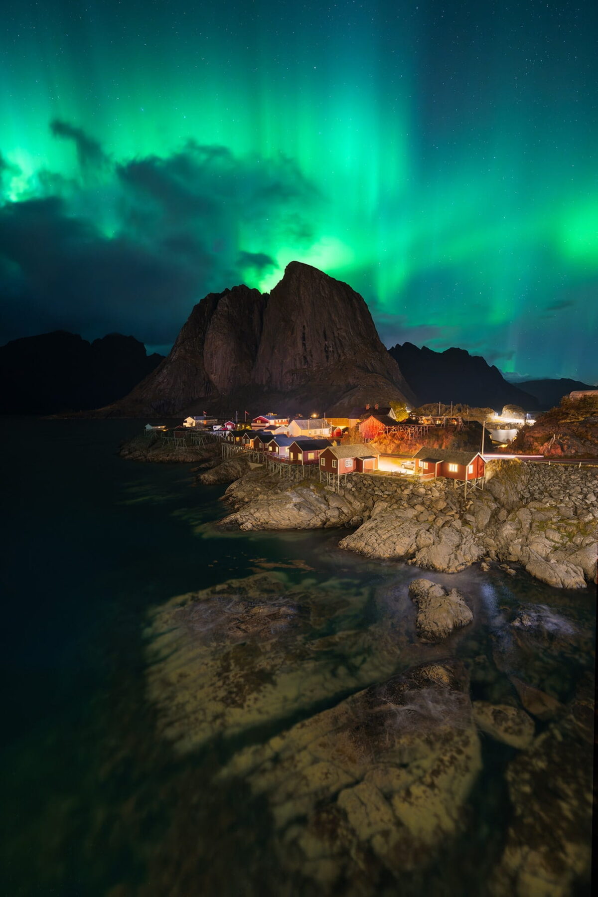 Aurora borealis above Hamnøy red cabins, Lofoten Islands, Norway