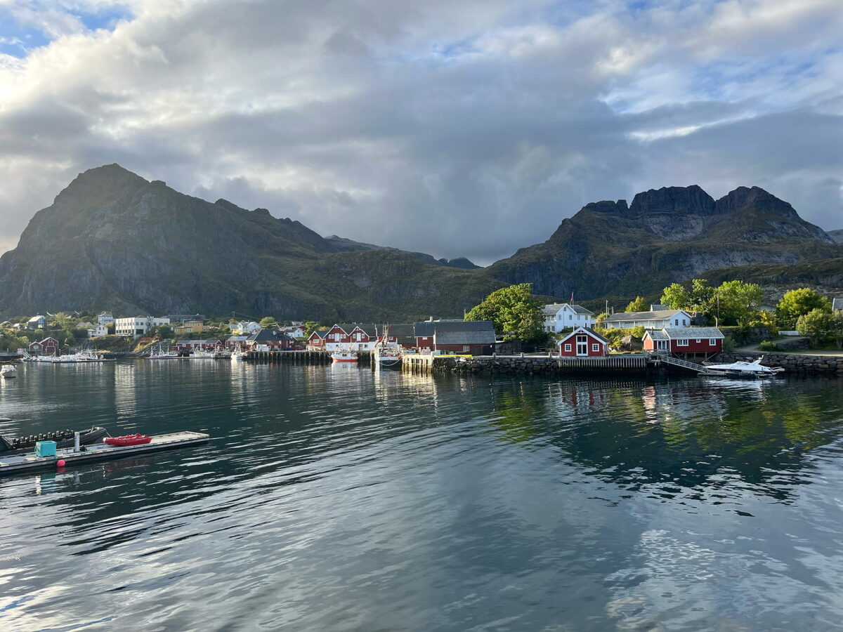 Sørvågen harbor with traditional red houses and mountains, Lofoten Islands, Norway