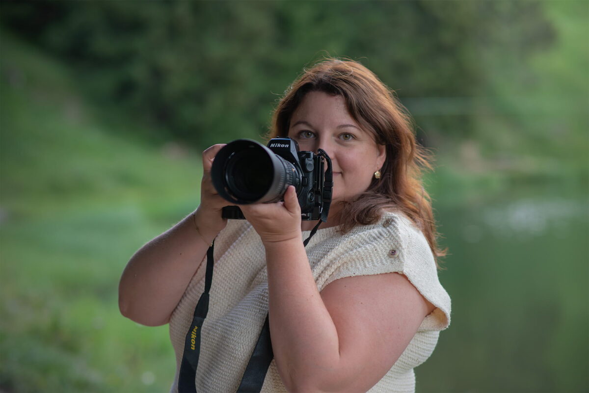 Landscape photographer using a Nikon Z8 with a Nikon AF-S NIKKOR 70-200mm f/4G ED VR telephoto lens during an outdoor photography session in Switzerland.