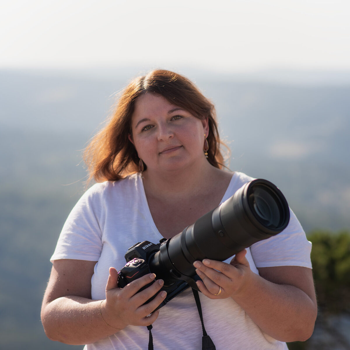Landscape photographer Jennifer Esseiva using a Nikon Z8 camera and NIKKOR Z 180-600mm telephoto lens during an outdoor photography session in Switzerland.